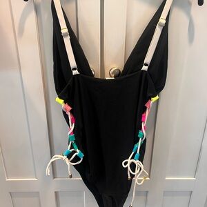 Like new size-Lg Black one piece, neon color open lacing on sides, gold accents